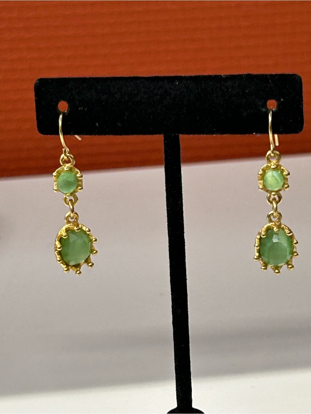 Gold tone green cats eye dangle earrings